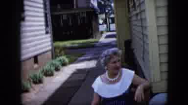 California USA (1969): Woman Conversing With Unseen Individual In Alley