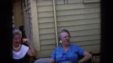 California USA (1969): An Old Couple Hugging And Two Elderly Women Sitting Outside