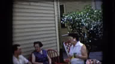 California USA (1969): People Sit Outside Of A Home During The Summer And Drink