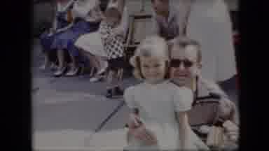 California USA (1969): A Happy Father Kissing His Son Goodbye And Two Friends