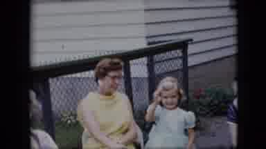California USA (1969): A Young Girl Smiling And Waving To A Video Camera In A Yard