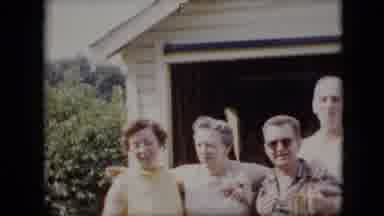 California USA (1969): Two Women, Two Men Posing In Front Of A Garage