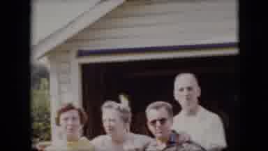 California USA (1969): Adults With Interlocked Arms Smiling And Laughing Outside