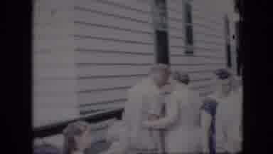 California USA (1969): People Talking Near House Some Sitting Laughing Greeting