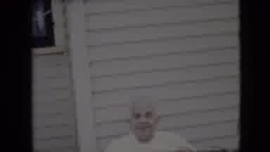 California USA (1969): Man In White Shirt In Front Of House