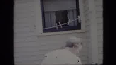 California USA (1969): Three Elderly Women Preparing To Dry Laundry By A House