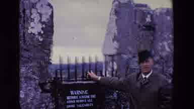 Ireland (1969): Man Posing For Video By Warning Sign Posted On Iron Gate