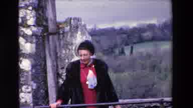 Ireland (1969): A Lady Standing, Wearing Dark Coat, Hat, Looking Around And Nearby