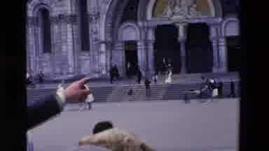 Loudes France (1969): A Man Showing A Group Of Tourists A Building While People