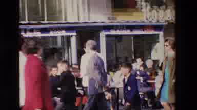 Loudes France (1969): People Walking Past An Outdoor Cafe With Many People Eating