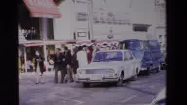 Loudes France (1969): Busy Street Scene People Walking Near Crowded Cafe And