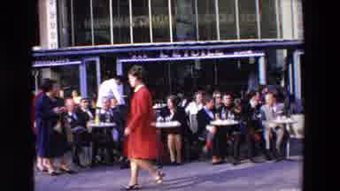 Loudes France (1969): People Sitting Outside Walking By Bystanders