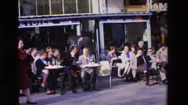 Loudes France (1969): People Walking On A Busy Street In Front Of People Sat At