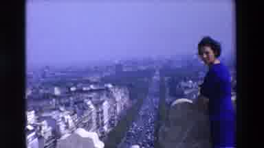 Loudes France (1969): Woman Standing Above A Roadway Filled With Traffic In An Old