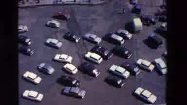 LOUDES FRANCE-1969: Aerial View of 1960s American Cars in a Parking Lot