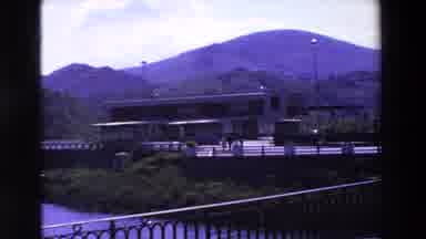 Loudes France (1969): Exterior Building Shot At Base Of Mountain Range