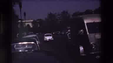 Paris France (1969): Relaxing White Car Drive By Parked Automobiles Behind Semi In