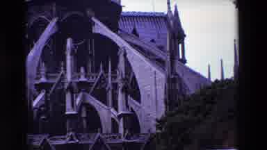 Paris France (1969): A Stone Building With Arches And Spires Sits Underneath An