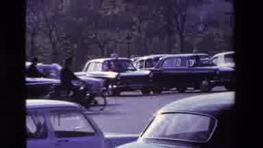 Paris France (1969): Two Bike Riders Weaving Through The Busy Streets