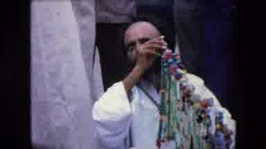 Algeria (1971): Moroccan Man Smoking Hookah In Town Market Surrounded By People