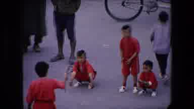 ALGERIA-1971: Children Playing In Red Uniforms On Street