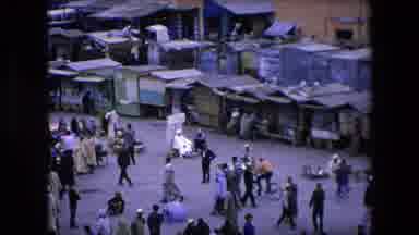 ALGERIA-1971: Bustling Marketplace With Traditional Clothing And Daily Life