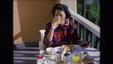 Algeria (1971): Brunette Woman In A Red And Blue Plaid Dress Drinking Orange Juice
