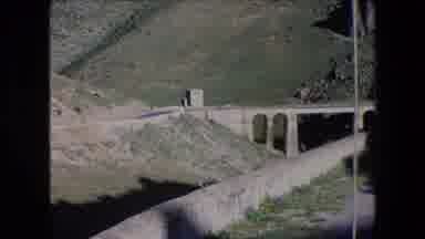 Algeria (1971): Car Driving Down Mountain Road And Across A Bridge