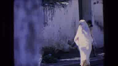 Algeria (1971): Woman Wearing Burqa Walks In Village Street