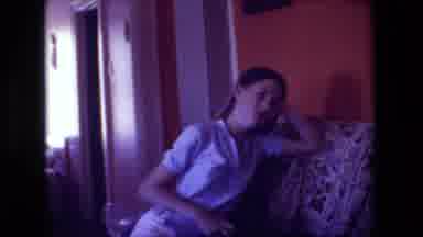 Hollywood California USA (1981): A Girl Sitting On The Couch Next To Her Laughing