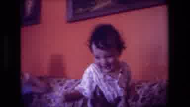 Hollywood California USA (1981): Family On Couch Toddler Laughing