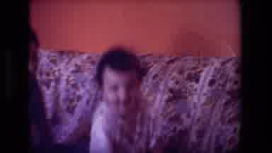 Hollywood California USA (1981): Older Child Bouncing Baby On The Couch