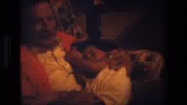 Lansing Michigan (1981): Grandfather Holding Sleeping Child