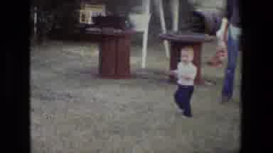 Lansing Michigan (1981): A Toddler Walking Across The Yard