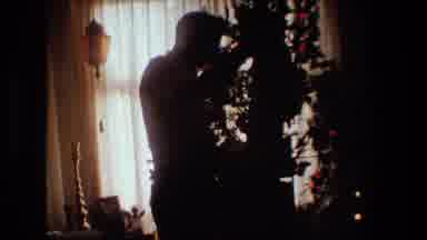 Lansing Michigan (1981): A Man Opening His Christmas Gift In Front Of The
