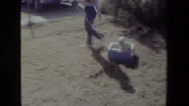 Lansing Michigan (1981): A Woman Pulling A Baby Girl Around In A Box In Their Yard