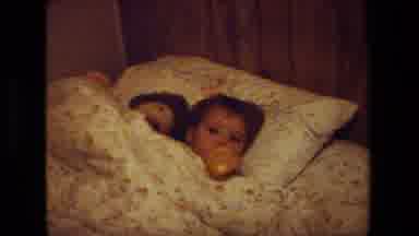 Malibu California USA (1981): Adult Holding Child And Child In Bed