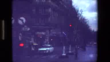 Paris France-1981: Vintage 8mm Street Scene at Dusk with Cars and Traffic Lights