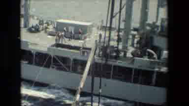 San Diego Naval Base (1981): Men In Orange And Grey Uniforms Pulling Rope On A