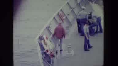 San Diego Naval Base (1981): A Man Walks Down Deck Of A Boat Near Two Other Men