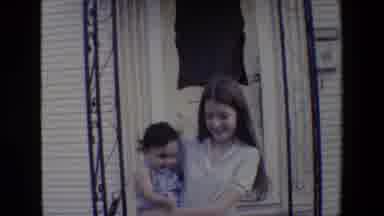 San Antonio Texas (1982): Girl With Long Hair Holding Baby On Threshold