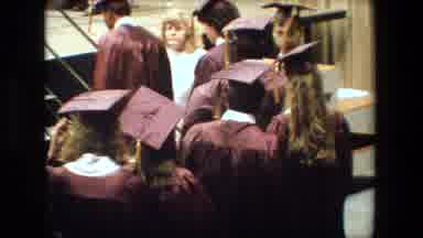 Lansing Michigan (1983): Female Graduate Walking Across Graduation Stage Towards
