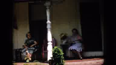 Pennsylvania USA (1958): Two Women Sitting On The Front Porch Relaxing Smiling And