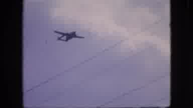 Philadelphia Pennsylvania USA (1964): A Twin-Engine Airplane Flies Under Overcast