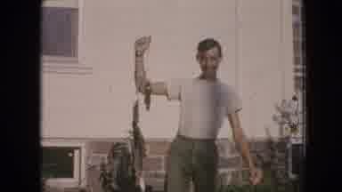 Philadelphia Pennsylvania USA (1964): A Young Man Smiling And Proudly Holding Up