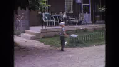 Philadelphia Pennsylvania USA (1964): Boy In A Navy Hat Dances In Front Of A House