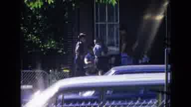 New Jersey USA (1965): Three Boys Talk Among Themselves Outside A Building