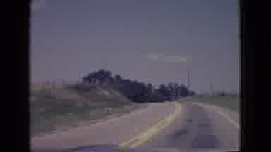 New Jersey USA (1965): A Vehicle Drives Down A Rural Highway In Daylight