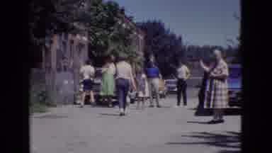 New Jersey USA (1965): Family Gathering Behind Buildings