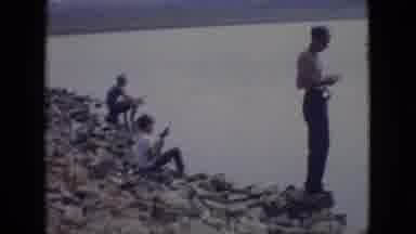 New Jersey USA (1965): Man And Boys Fish On Rocky Beach